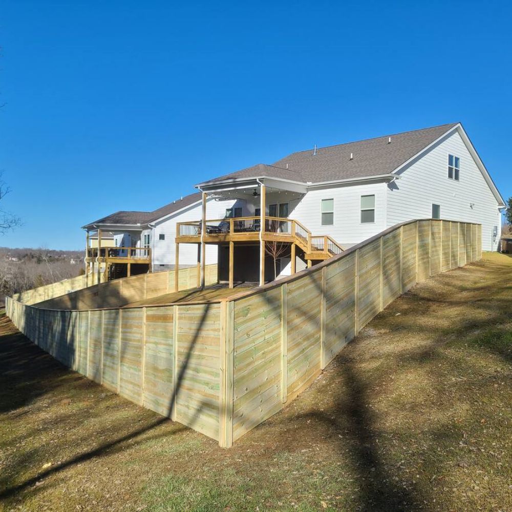Wooden Fence on a backyard with a slope.